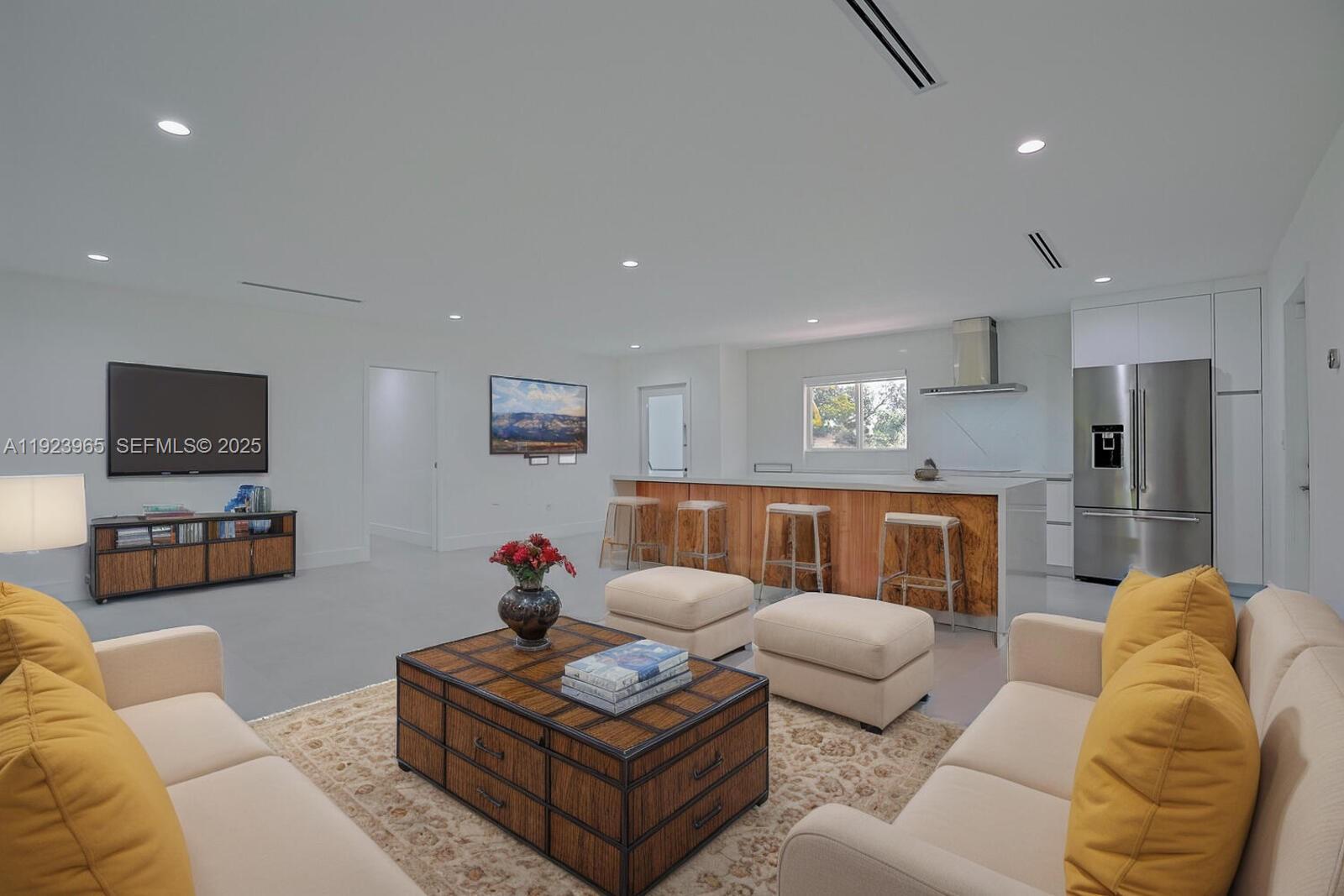 9301 Southwest 178th Street Palmetto Bay, FL 33157 - Photo 10 of 23 a living room with furniture and a flat screen tv
