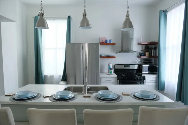 a kitchen with a table and chairs