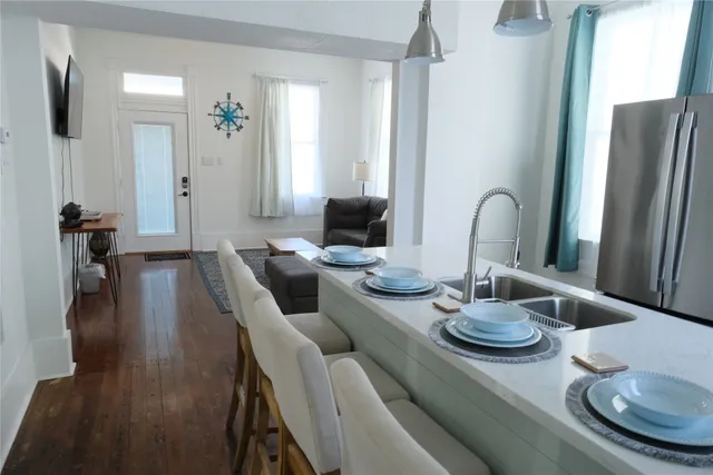 a dining room with furniture and wooden floor