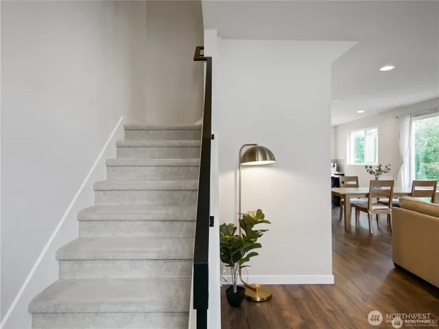 a view of entryway and hall with wooden floor