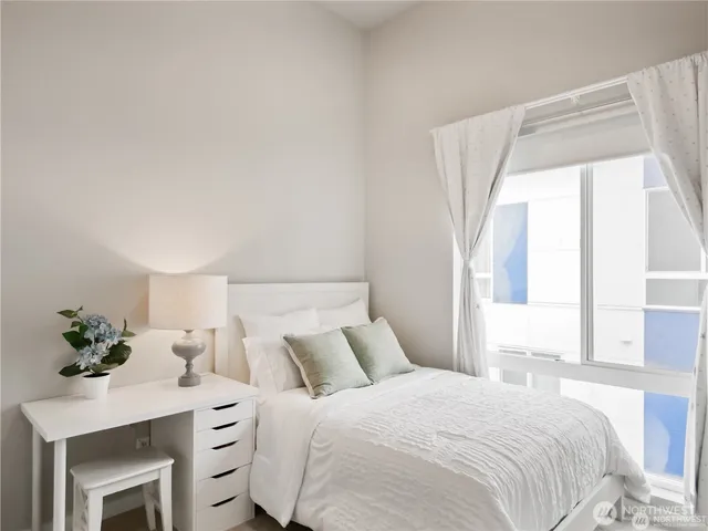 a bedroom with a bed and a potted plant