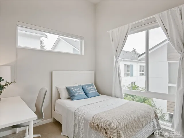 a bedroom with a large bed and a window