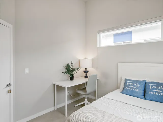 a bedroom with a bed and a potted plant