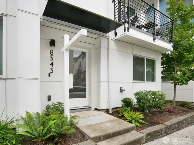 a front view of a house with white walls