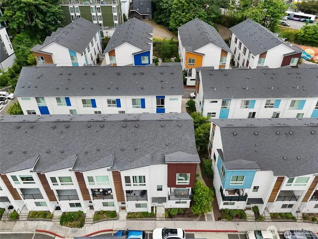 an aerial view of multiple houses with a yard