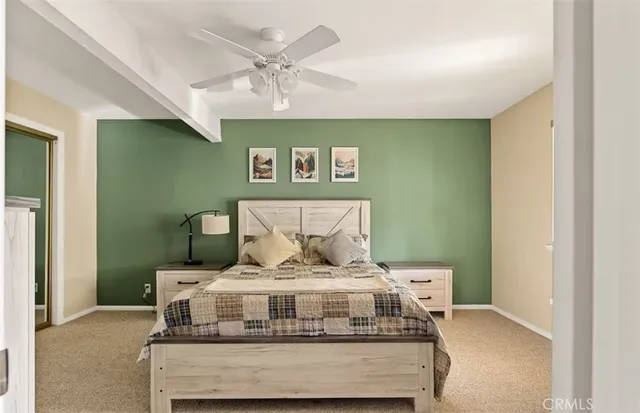 a bed sitting in a room next to a lamp