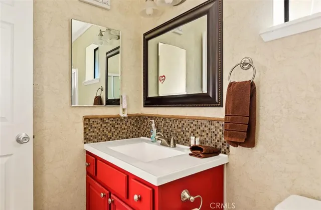 a bathroom with a sink vanity and a mirror