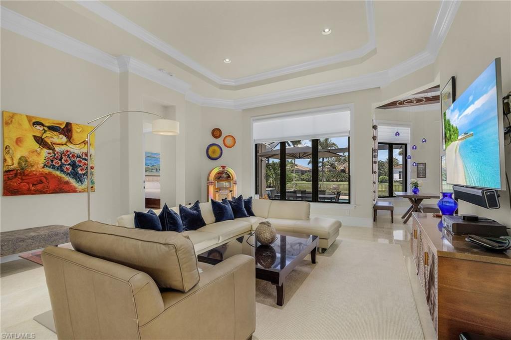2220 Residence Circle Naples, FL 34105 - Photo 12 of 50 Living room featuring a raised ceiling, ornamental molding, and recessed lighting