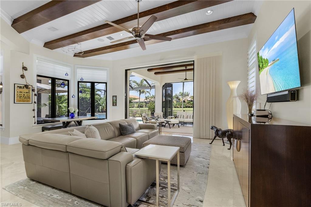 2220 Residence Circle Naples, FL 34105 - Photo 13 of 50 Living room with healthy amount of natural light, ceiling fan, a sunroom, and a wood ceiling with exposed beams