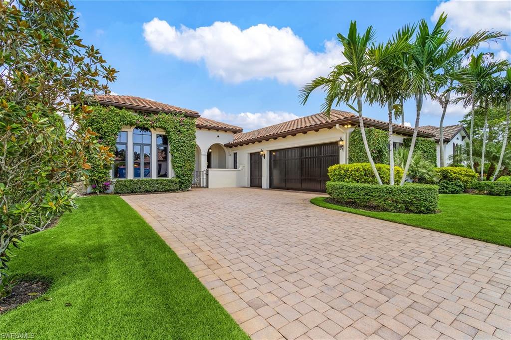 2220 Residence Circle Naples, FL 34105 - Photo 2 of 50 Mediterranean / spanish home with a front lawn, an attached garage, decorative driveway, stucco siding, and a tile roof