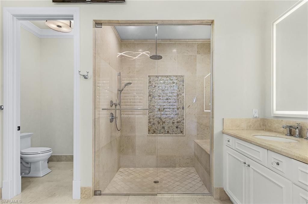 2220 Residence Circle Naples, FL 34105 - Photo 21 of 50 Bathroom featuring vanity, a stall shower, and ornamental molding