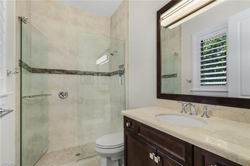 2220 Residence Circle Naples, FL 34105 - Photo 25 of 50 Bathroom featuring vanity and a shower stall