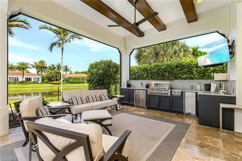 2220 Residence Circle Naples, FL 34105 - Photo 28 of 50 View of patio featuring an outdoor hangout area, a water view, an outdoor kitchen, and ceiling fan