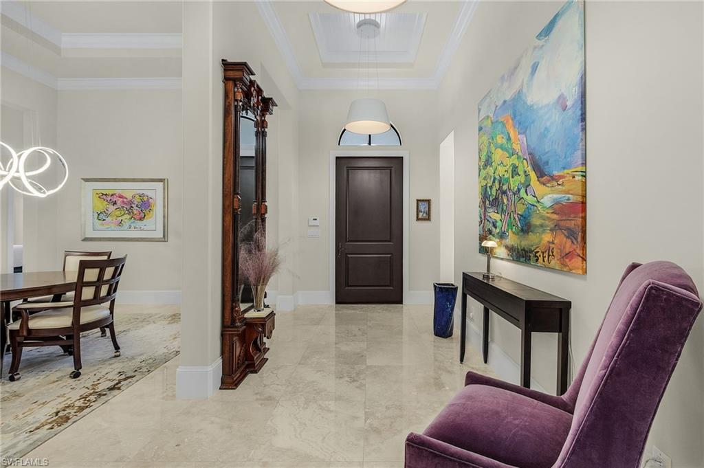 2220 Residence Circle Naples, FL 34105 - Photo 31 of 50 Foyer featuring a tray ceiling and ornamental molding