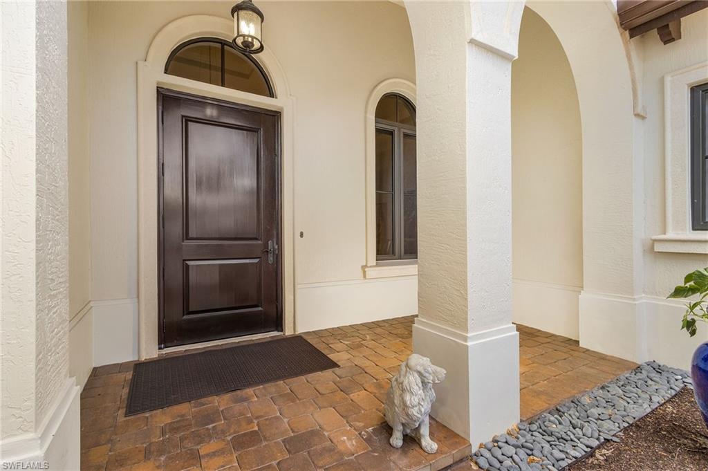 2220 Residence Circle Naples, FL 34105 - Photo 32 of 50 View of exterior entry featuring stucco siding and a porch