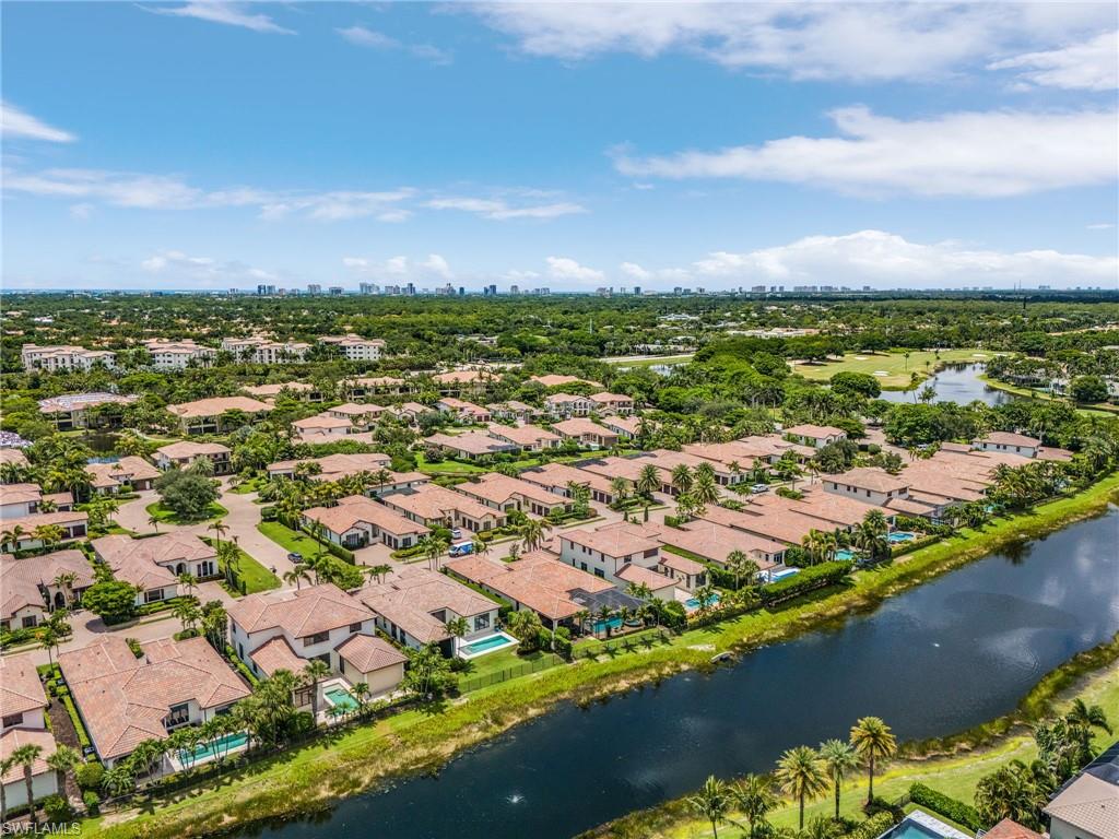 2220 Residence Circle Naples, FL 34105 - Photo 43 of 50 Aerial perspective of suburban area featuring a large body of water and city skyline