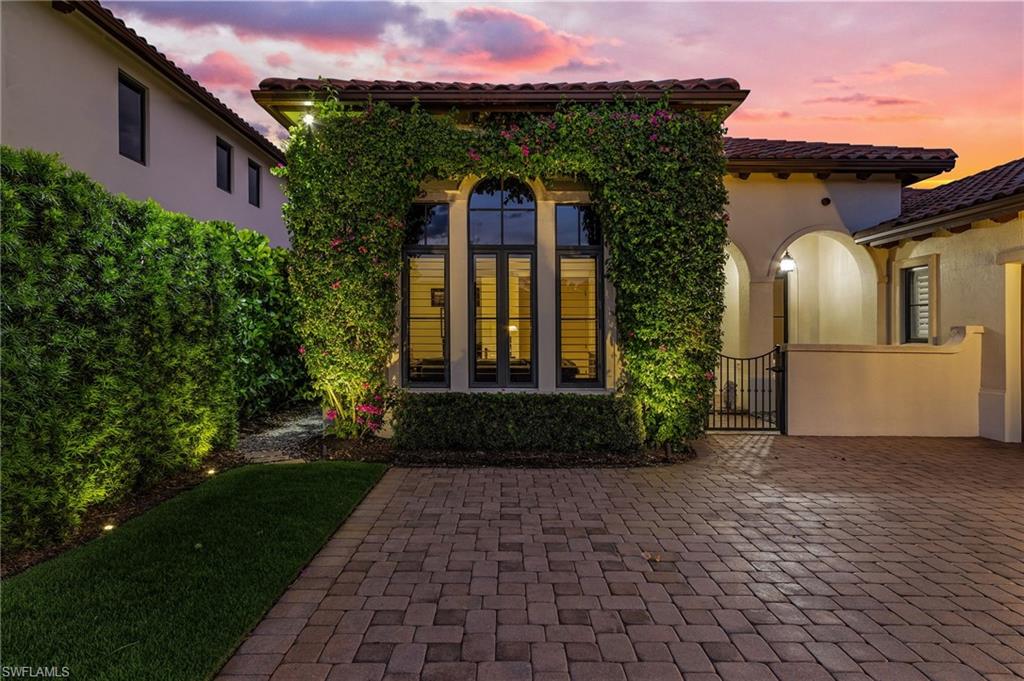 2220 Residence Circle Naples, FL 34105 - Photo 48 of 50 Rear view of house featuring a tile roof, stucco siding, a gate, and a patio area