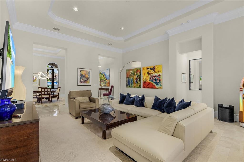 2220 Residence Circle Naples, FL 34105 - Photo 6 of 50 Living room featuring a tray ceiling, ornamental molding, and recessed lighting