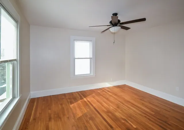 wooden floor in an empty room with a window