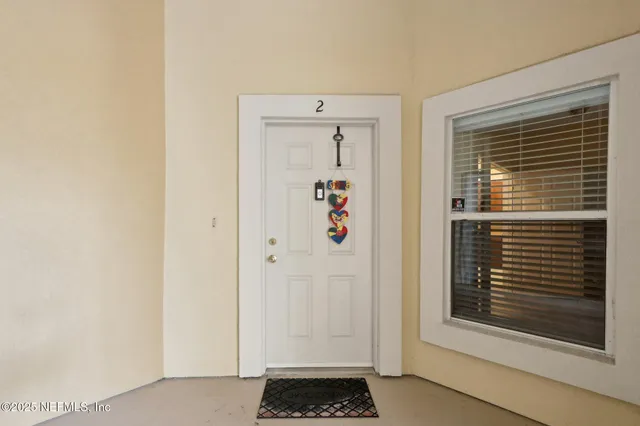 a view of a hallway with wooden floor and a dining room