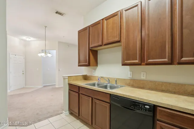 a kitchen with stainless steel appliances granite countertop a sink a stove and a microwave oven