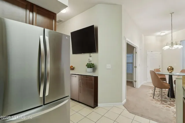 a kitchen with stainless steel appliances granite countertop a refrigerator and a stove