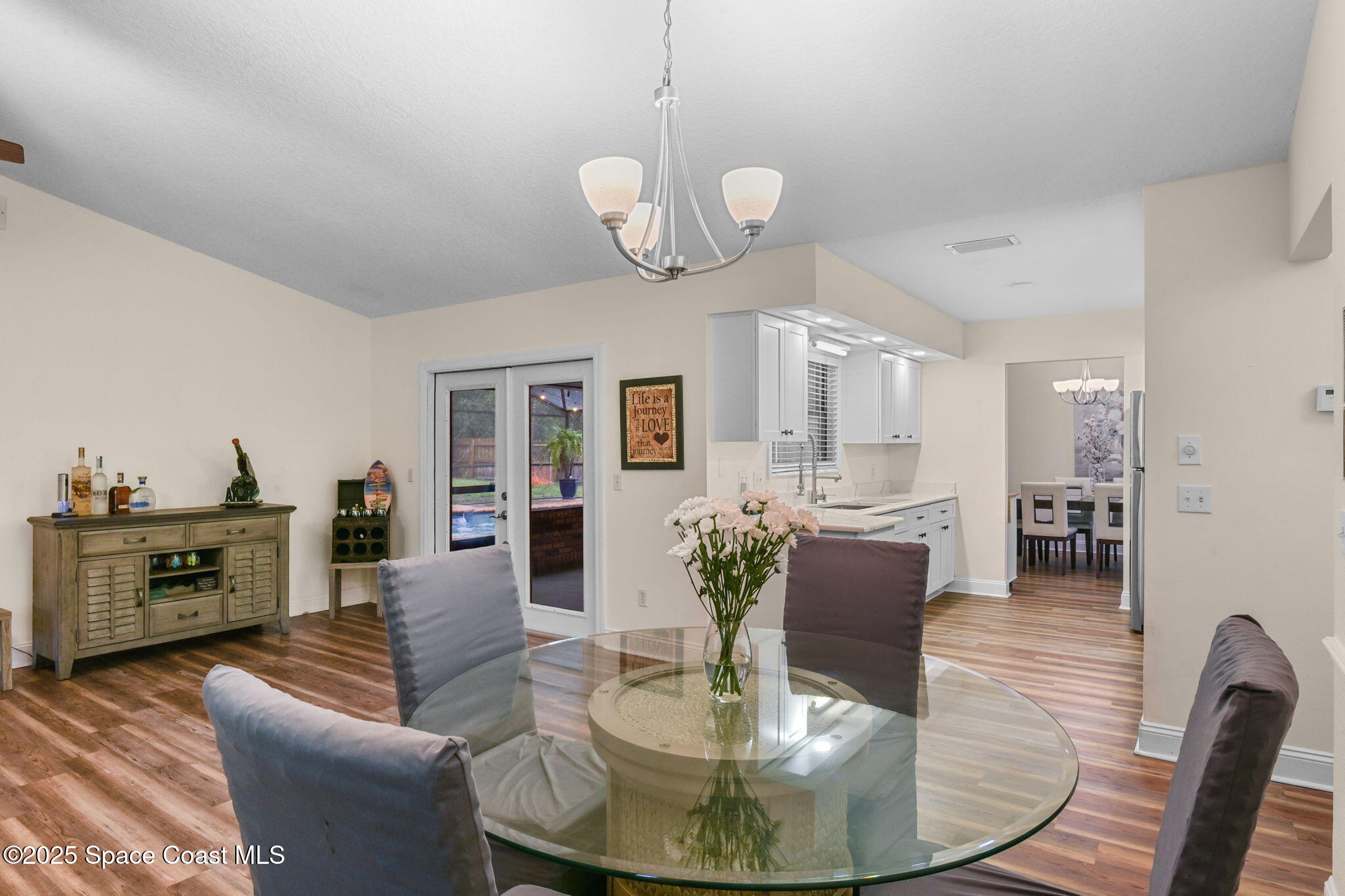 1873 Carrin Street Deltona, FL 32738 - Photo 16 of 54 a view of a dining room with furniture a chandelier and wooden floor