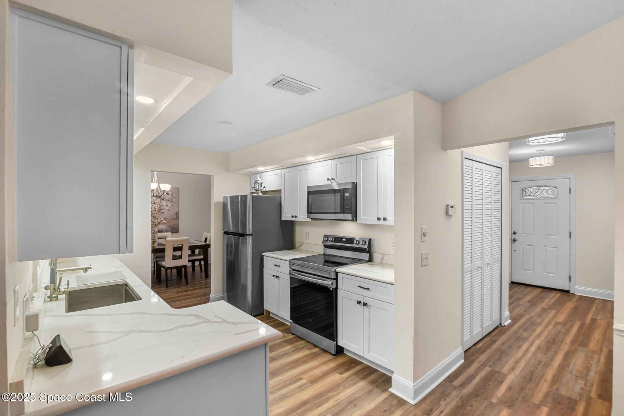 1873 Carrin Street Deltona, FL 32738 - Photo 17 of 54 a kitchen with stainless steel appliances kitchen island sink refrigerator and stove