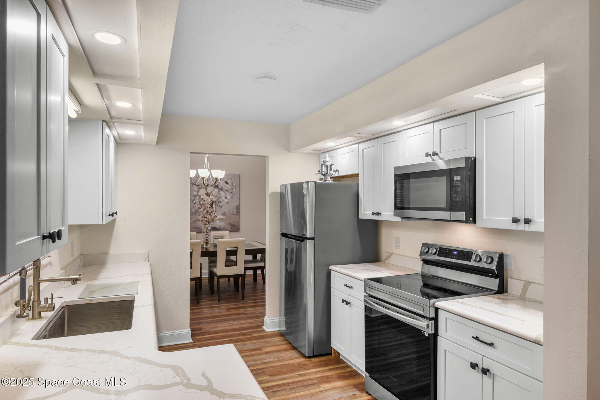 1873 Carrin Street Deltona, FL 32738 - Photo 18 of 54 a kitchen with a sink stainless steel appliances and cabinets