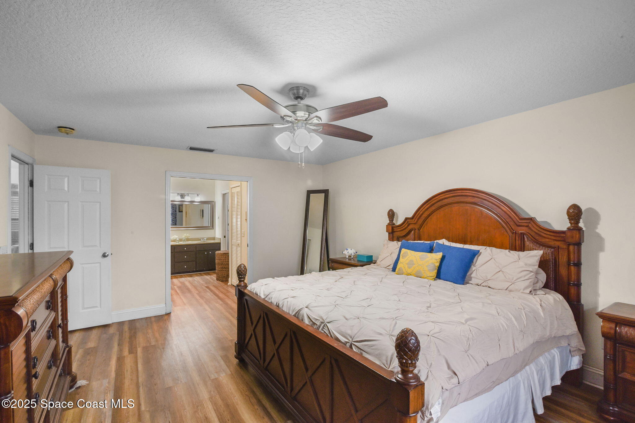 1873 Carrin Street Deltona, FL 32738 - Photo 23 of 54 a bedroom with a bed and a chandelier