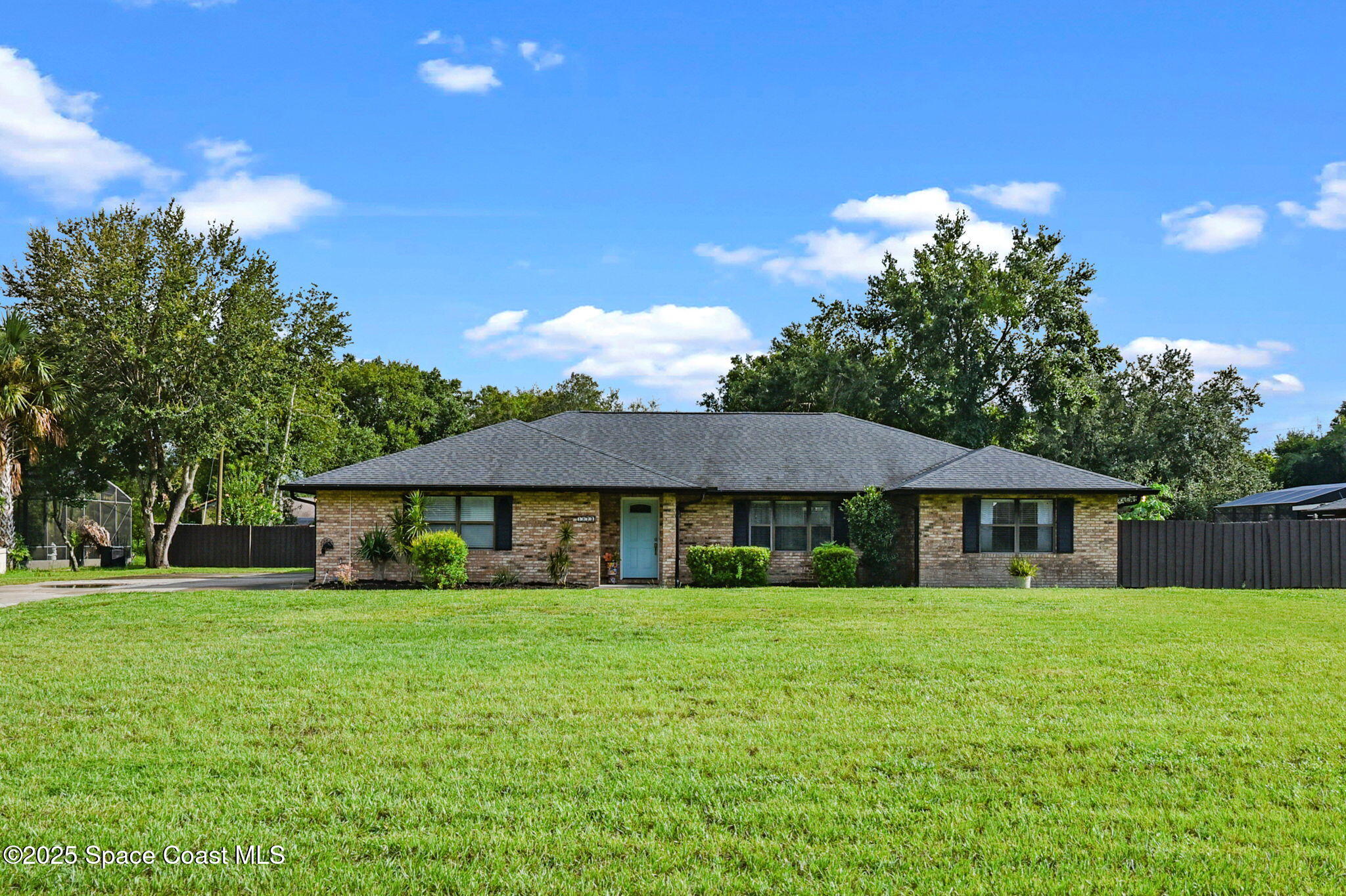 1873 Carrin Street Deltona, FL 32738 - Photo 3 of 54 a front view of a house with a garden