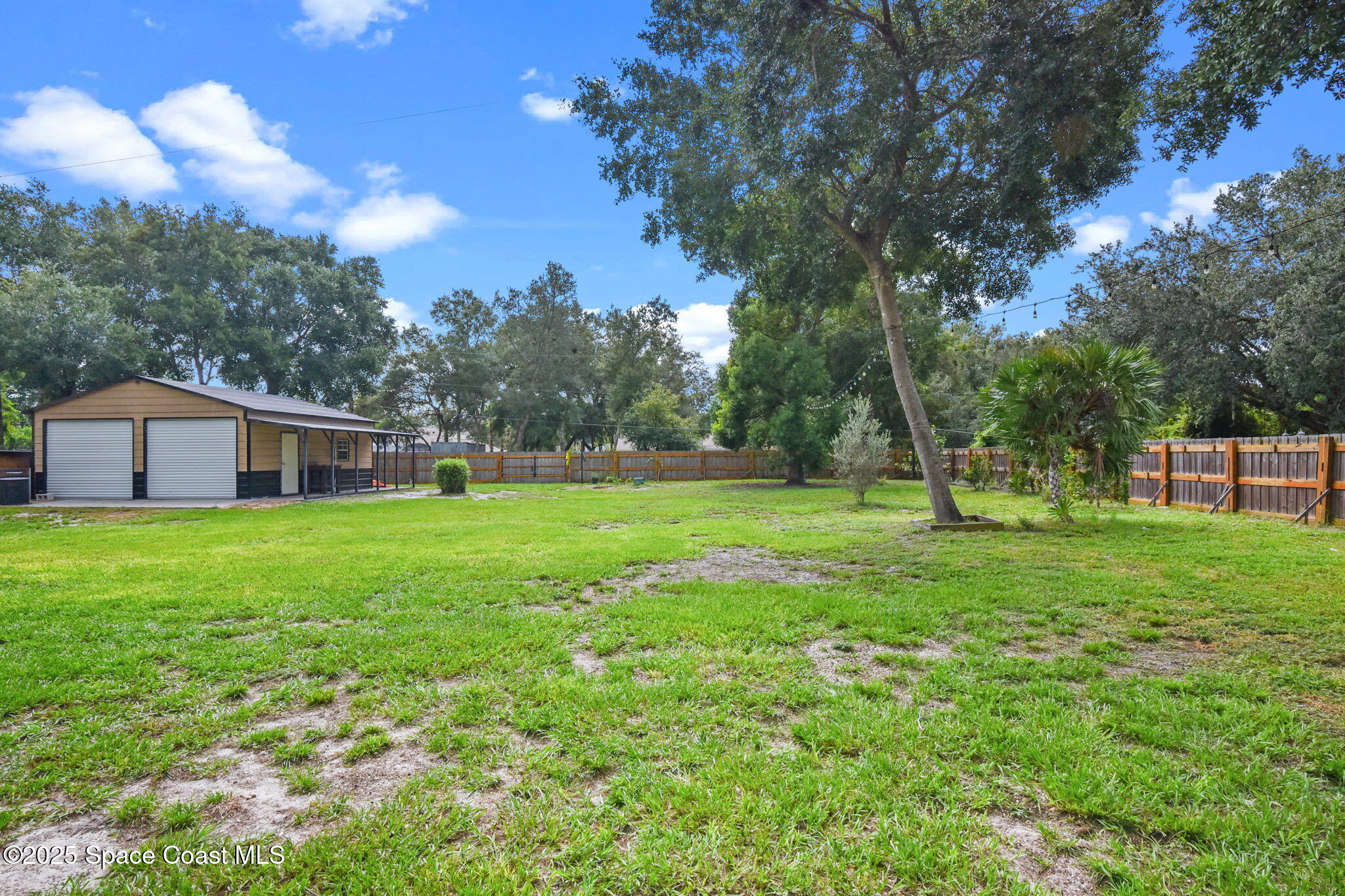 1873 Carrin Street Deltona, FL 32738 - Photo 40 of 54 a view of a house with backyard and a tree