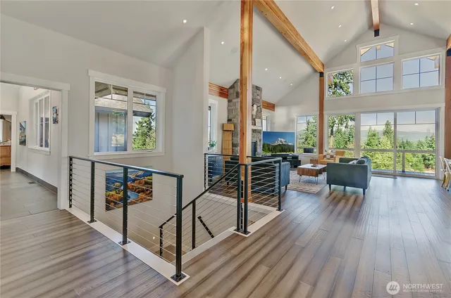 a very nice looking living room with a large window and wooden floor