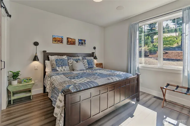 a bedroom with a bed a table and chair