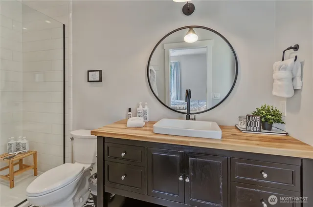 a bathroom with a toilet a sink and a mirror