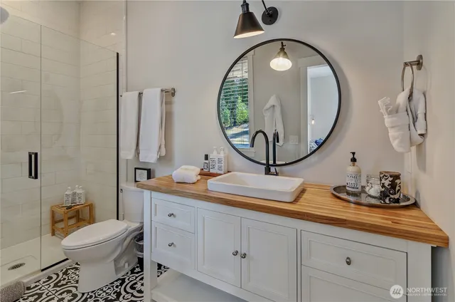 a bathroom with a toilet a sink and a mirror