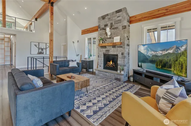 a living room with furniture a flat screen tv and a fireplace