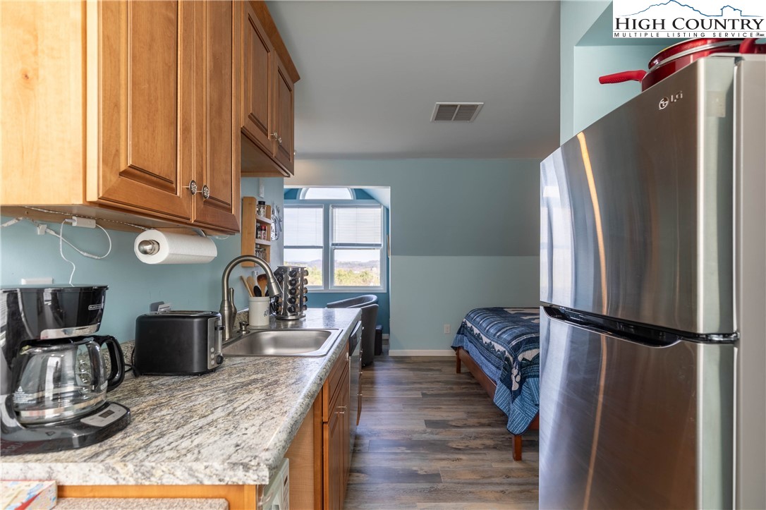 449 Meadow Ridge Drive Jefferson, NC 28640 - Photo 27 of 37 a kitchen with stainless steel appliances granite countertop a refrigerator and a stove