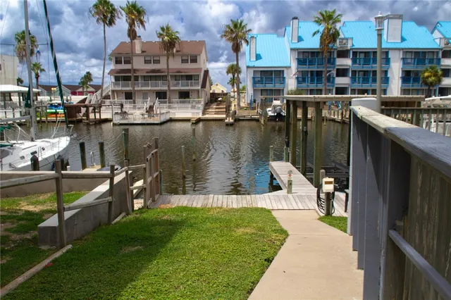 a view of a lake with a building and outdoor seating