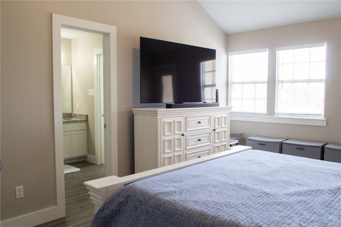 14439 Compass Street, Unit B Corpus Christi, TX 78418 - Photo 11 of 22 a bedroom with a bed and a flat screen tv