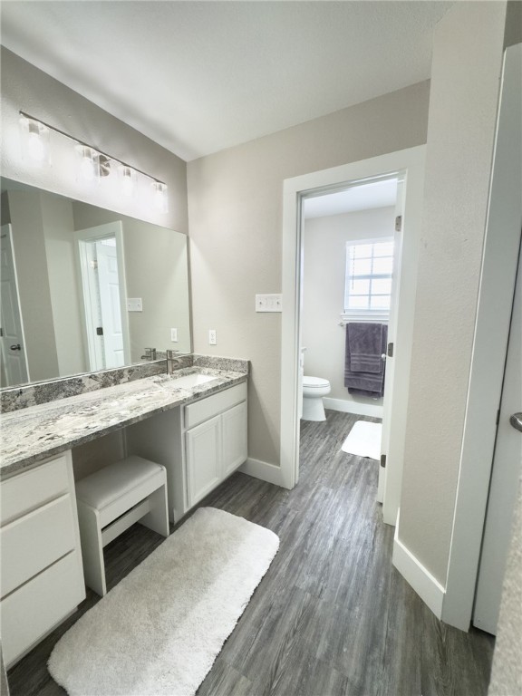 14439 Compass Street, Unit B Corpus Christi, TX 78418 - Photo 12 of 22 a large white kitchen with a sink and dishwasher with wooden floor