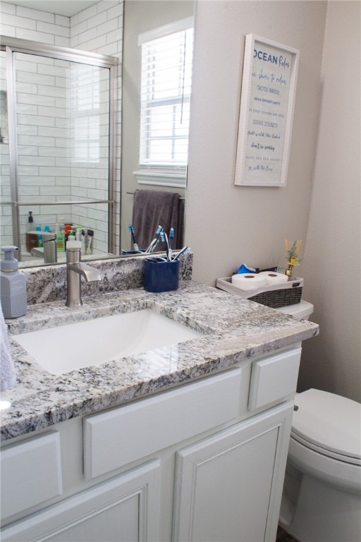 14439 Compass Street, Unit B Corpus Christi, TX 78418 - Photo 14 of 22 a bathroom with a granite countertop sink a toilet and a bathtub