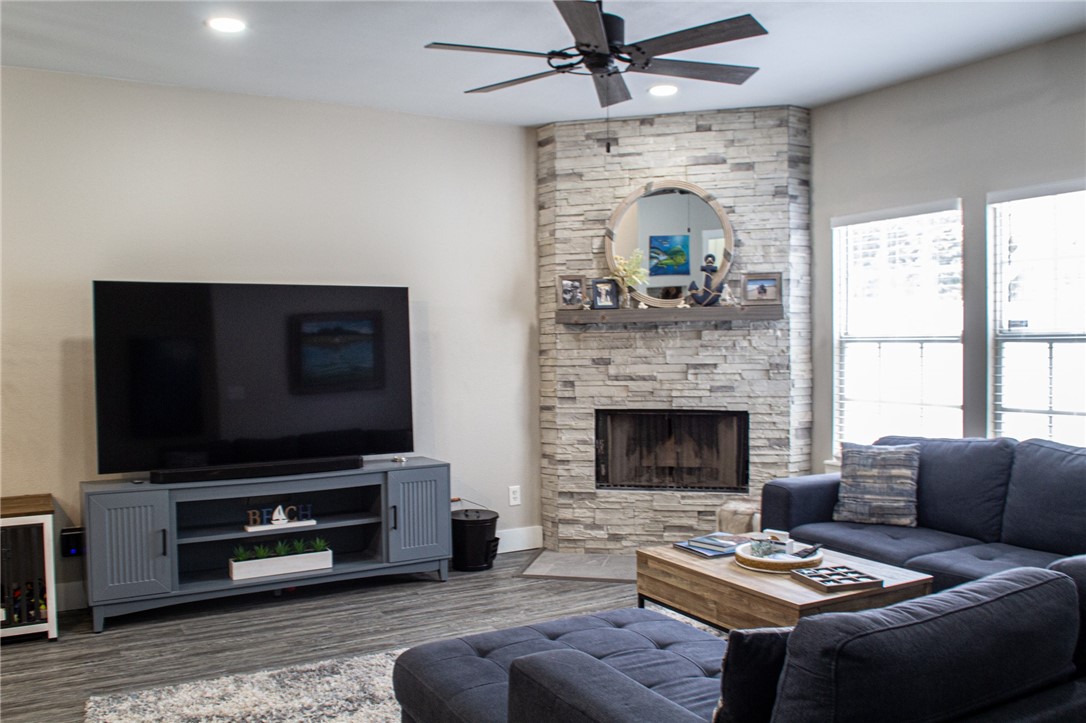 14439 Compass Street, Unit B Corpus Christi, TX 78418 - Photo 5 of 22 a living room with furniture a flat screen tv and a fireplace