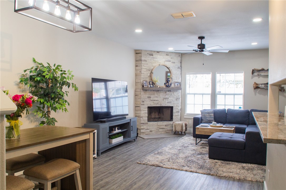 14439 Compass Street, Unit B Corpus Christi, TX 78418 - Photo 6 of 22 a living room with furniture a flat screen tv and a fireplace