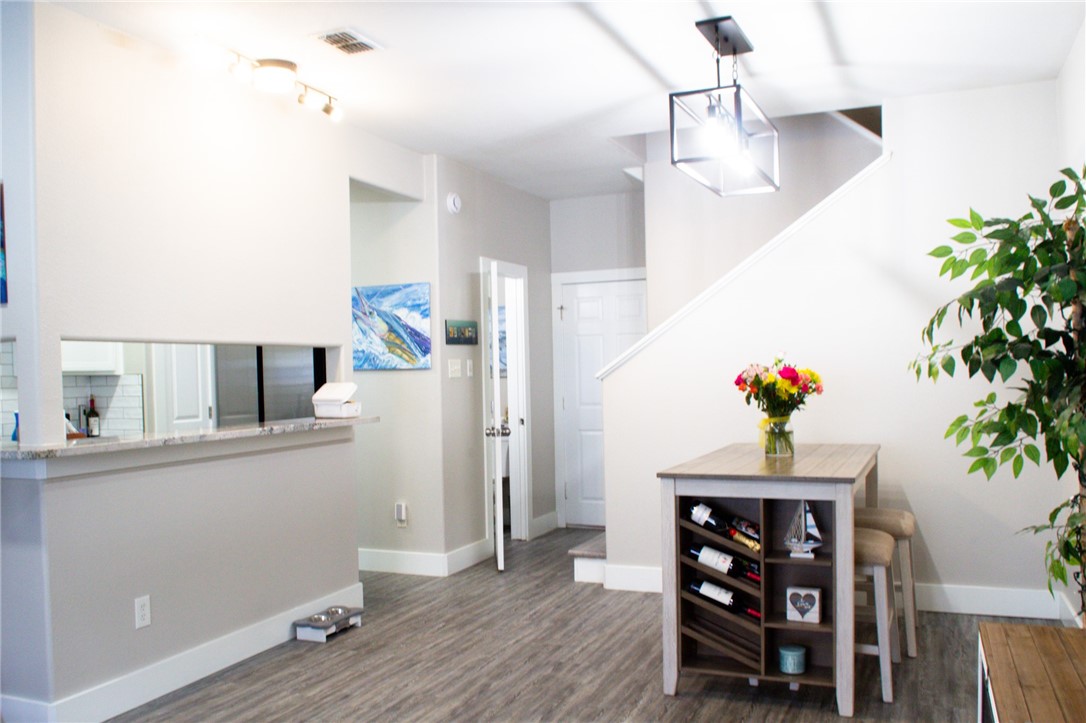14439 Compass Street, Unit B Corpus Christi, TX 78418 - Photo 7 of 22 a view of a workspace with furniture and wooden floor