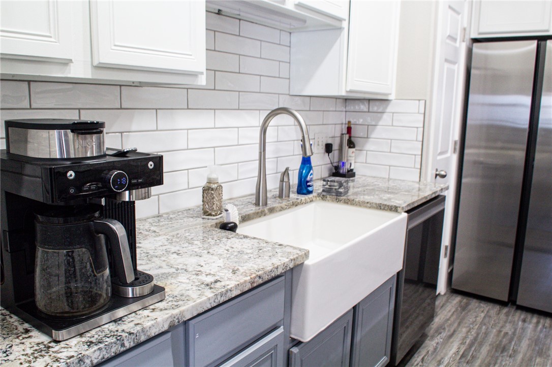 14439 Compass Street, Unit B Corpus Christi, TX 78418 - Photo 8 of 22 a kitchen with granite countertop a sink a stove and refrigerator