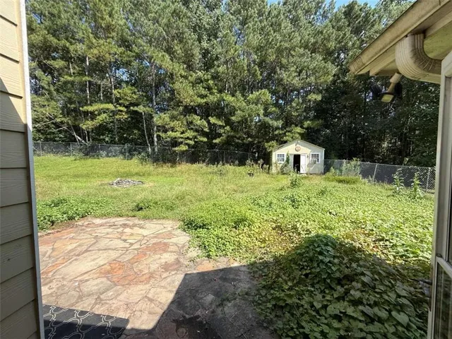 a backyard of a house with lots of green space and fountain
