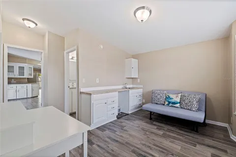 a spacious bedroom with a bed and cabinet