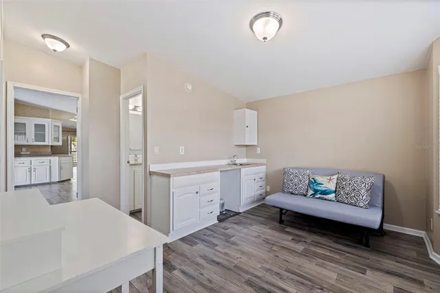 a spacious bedroom with a bed and cabinet