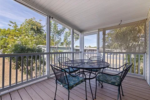 a view of a chairs and table in the balcony
